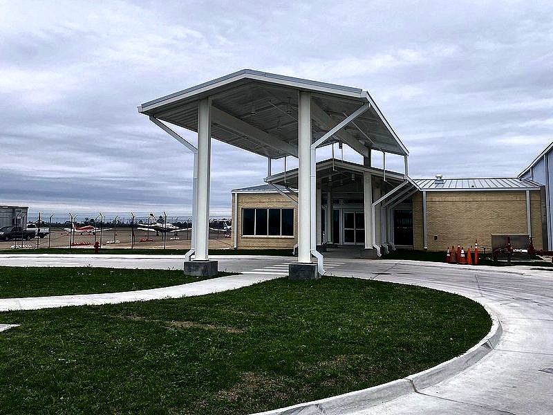 White steel entry canopy at an airport terminal