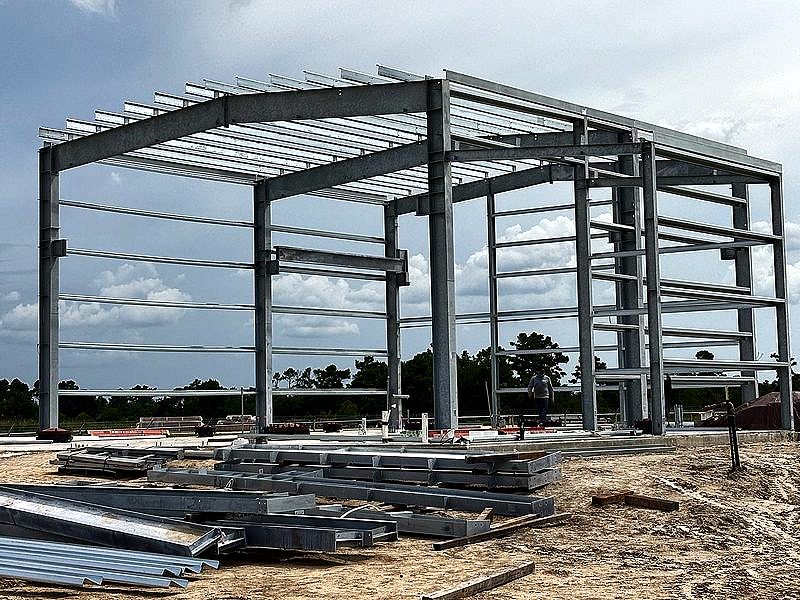 Galvanized steel building frame under storm clouds