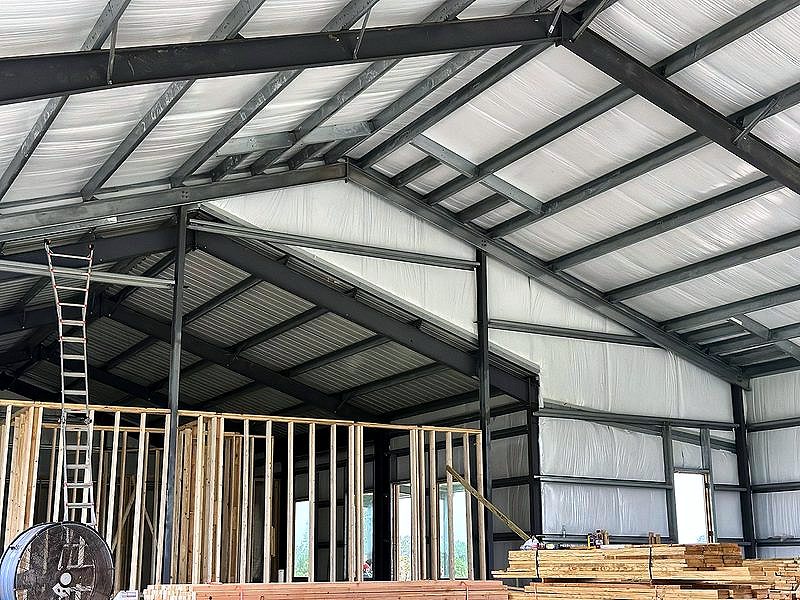 Interior steel roof framing with wood stud walls below