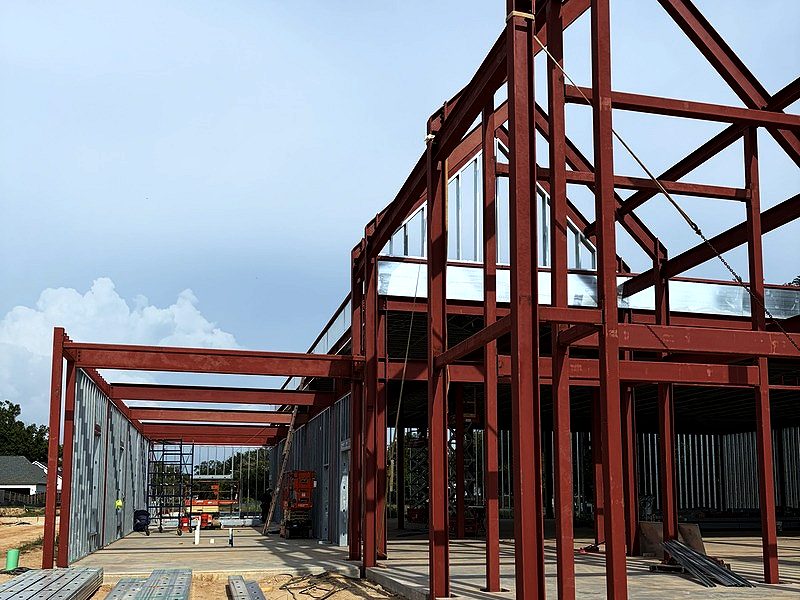 Red-iron structural steel frame with light-gauge wall framing at the gable end