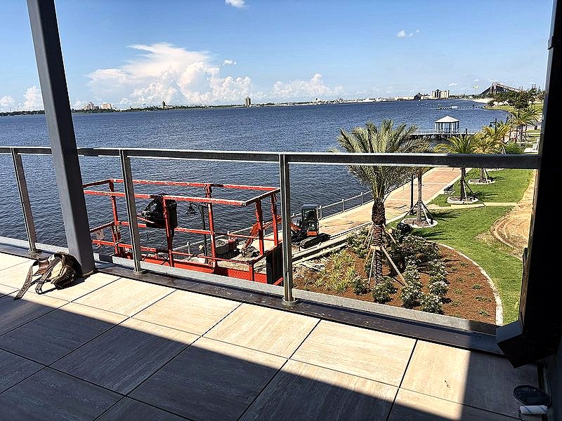 Balcony railing overlooking a river and park