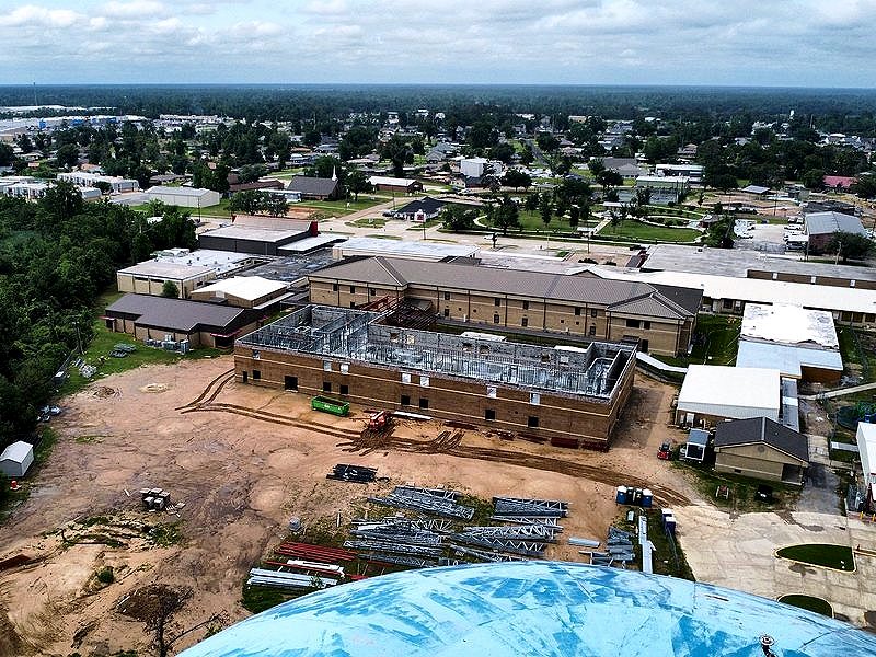 Aerial view of a two-story building addition under construction