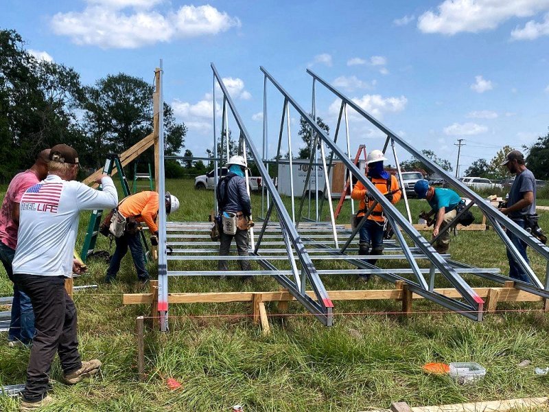 Crew assembling light-gauge metal trusses