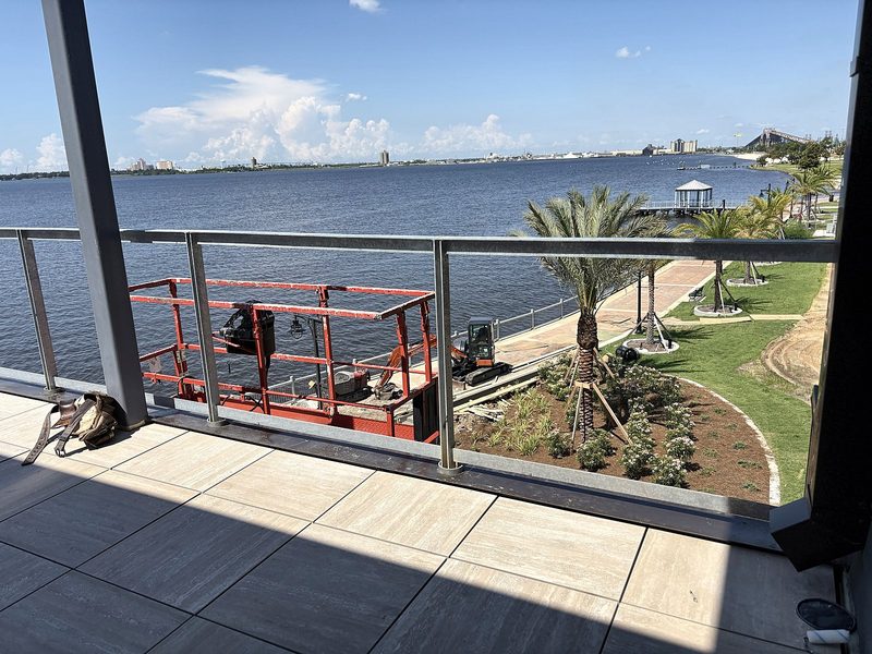 Balcony railing overlooking a river and park