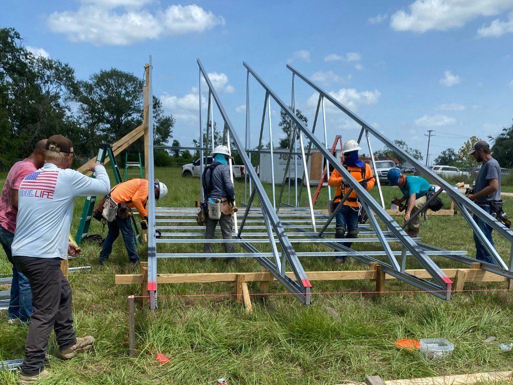 Crew assembling light-gauge metal trusses